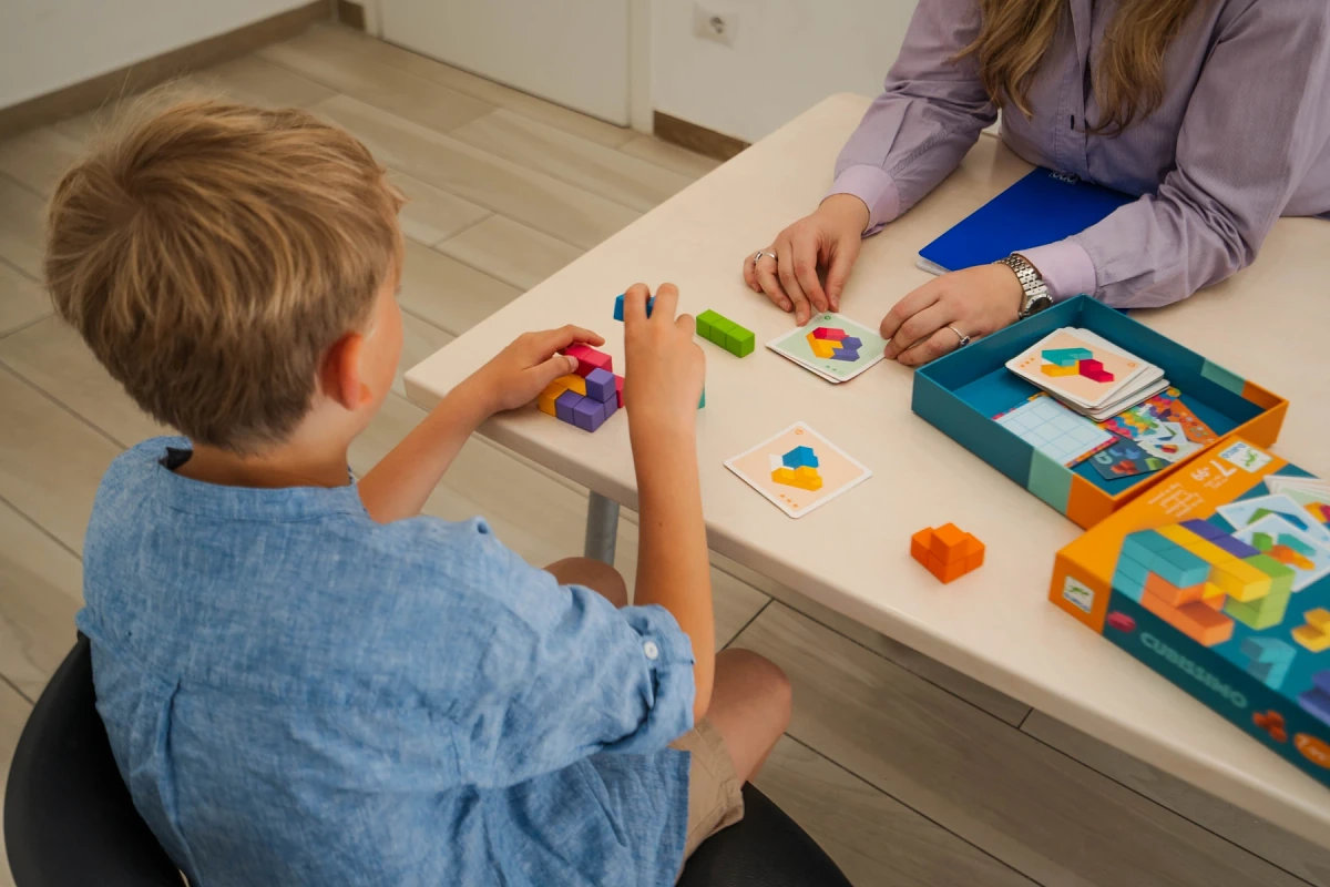 A child playing with colourful blocks during a speech therapy session at the practice in Viterbo