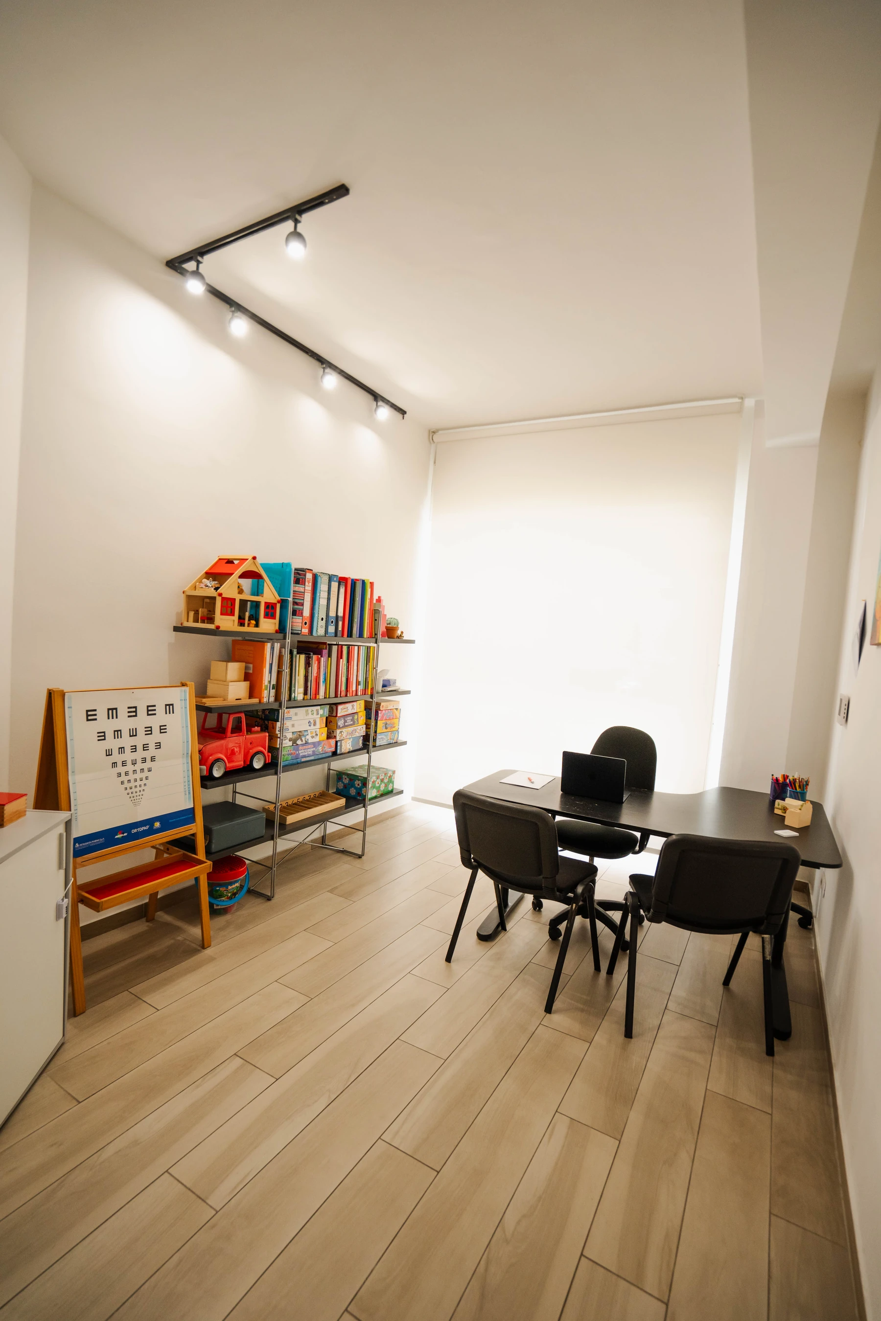Room with shelves of materials at the speech and language therapy practice in Viterbo